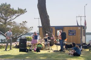 The Cookie Monsters performing in front of the NCI Stone Point station on the Clifftop